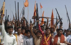 Activists of Bajrang Dal hold their weapons in Agra